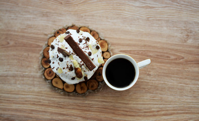 Morning, breakfast. White cup of coffee. Americano, Espresso on a wooden background with beautiful bite pastries. Place for text