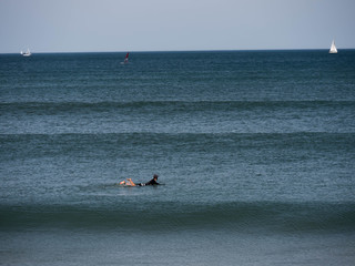 Surfer in perfect waves in the Basque Country in Spain on a nice summer day