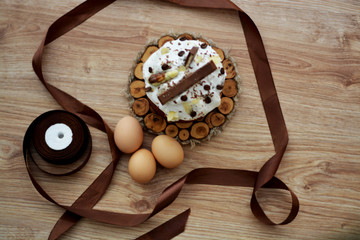 Easter holiday, eggs baking on a wooden background wrapped in a brown ribbon. Place for text