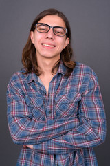 Young handsome hipster man with long hair