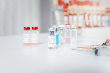 Sample of coronavirus vaccine (COVID-19) on work table in a medical lab.