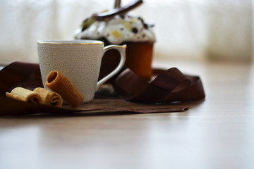 Morning, breakfast. White cup of coffee. Americano, Espresso on a wooden background with beautiful bite pastries. Place for text