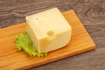 Emmental cheese over wooden board