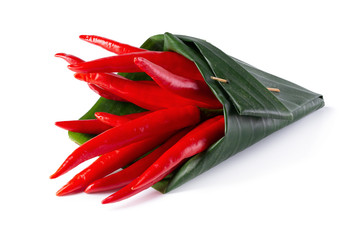 Red chili peppers Wrapped in banana leaves isolated on a white background