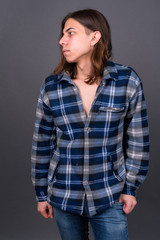 Young handsome hipster man with long hair