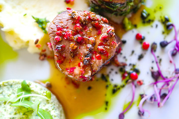 Fried meat with whole pepper and spice butter