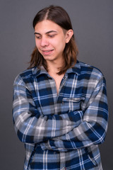 Fototapeta premium Young handsome hipster man with long hair