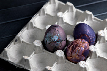 Colored Easter eggs on a light wooden table. Chicken eggs are painted for the Easter holiday.