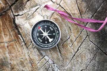Fototapeta na wymiar Old iron compass on wooden background