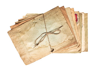 Shifted stack of worn dirty old letters tied with cord