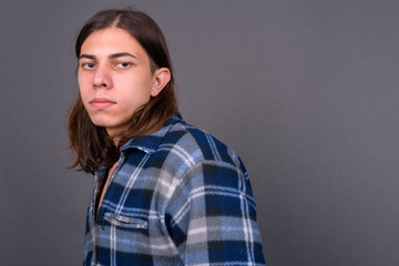 Obraz premium Young handsome hipster man with long hair