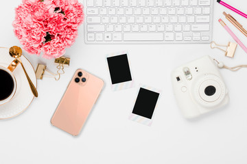 Pink office details with electronics and desk accessories in a white background