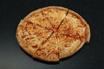 cheese pizza on dark background