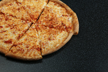 cheese pizza on dark background