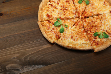 cheese pizza on dark wooden background