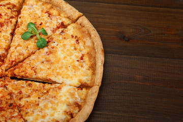 cheese pizza on dark wooden background
