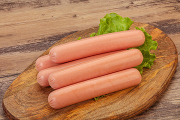 Tasty meat sausages over board