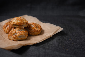 Buns from the furnace craft, food paper
Photo on a dark background.
