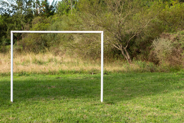 Soccer goal on a practice field. Space for sport without a person. White painted pipes forming an arc