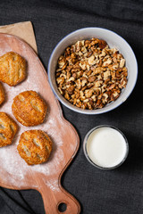 Food on a wooden board.
Baking, rolls, bread. Milk in a glass.
Sprinkled nuts
