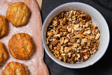 Baking, rolls, bread and sprinkled nuts. Kraft, food paper and wooden board