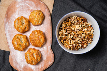 Baking, rolls, bread and sprinkled nuts. Kraft, food paper and wooden board