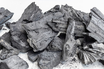 A pile of charcoal on white background.