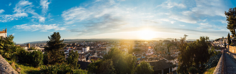 Aerial view of the skyline of the city of Granada with the rays of the sunset