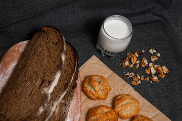 Baking, rolls, bread and sprinkled nuts. Kraft, food paper and wooden board