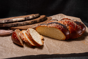 Baking, rolls, bread and milk on a dark background