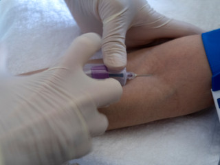 Fototapeta na wymiar covid-19. nurse will take a blood sample from a vein for coronavirus testing.