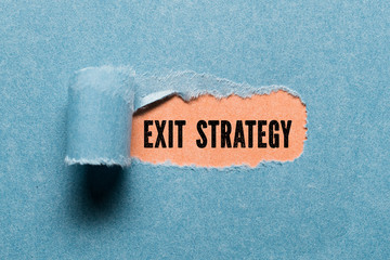 torn paper revealing a document with the text EXIT STRATEGY