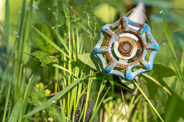 A rusty water valve at a camp site.