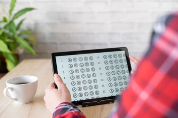 Online exam. girl student testing exercise. Examination test on the tablet for school, university. multiple choice answer sheet. Home school, online study. Pandemic, online study