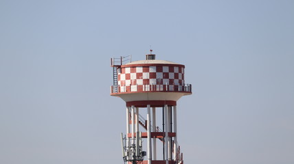 A big water reservoir placed on top of the tower.