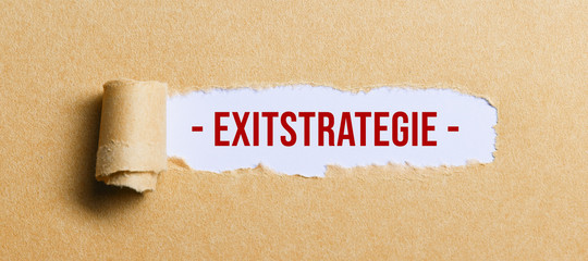 torn paper revealing a document with the German text for EXIT STRATEGY