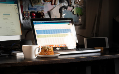 enjoy with fresh and delicious almonds croissant with coffee and ready to work at home. Focus at croissant.