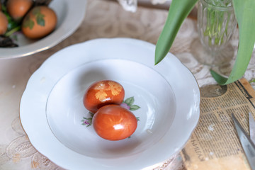 A painted egg with an ornament in a plate for Easter