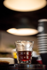 Glass of black filter coffee hario pour over sunlight daylight coffee house cafe