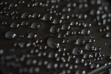 Close up of water droplets on black plastic