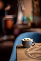 Cup of coffee cappuccino on wooden table texture daylight sunlight cafe coffee house restaurant