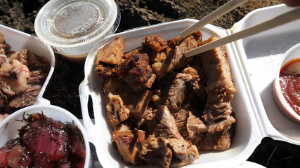Street food. Meat with disposable dishes. Picnic.