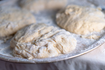 Flour dough sprinkled on a tray