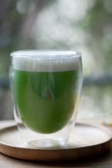 Iced green tea with milk foam.