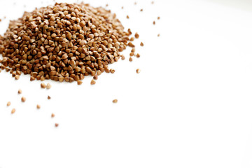 Background, texture-buckwheat on a white background. The concept of healthy, proper nutrition, vegetarianism.
