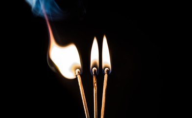 burning matches on a black background