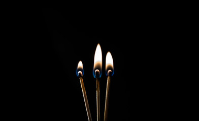 burning matches on a black background