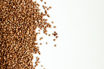 Background, texture-buckwheat on a white background. The concept of healthy, proper nutrition, vegetarianism.