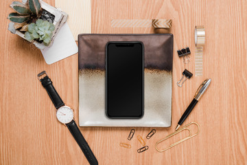 Office desk accessories and electronics  in a woody background
