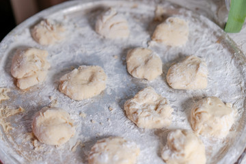 Preparing a pastry for baking buns with jam